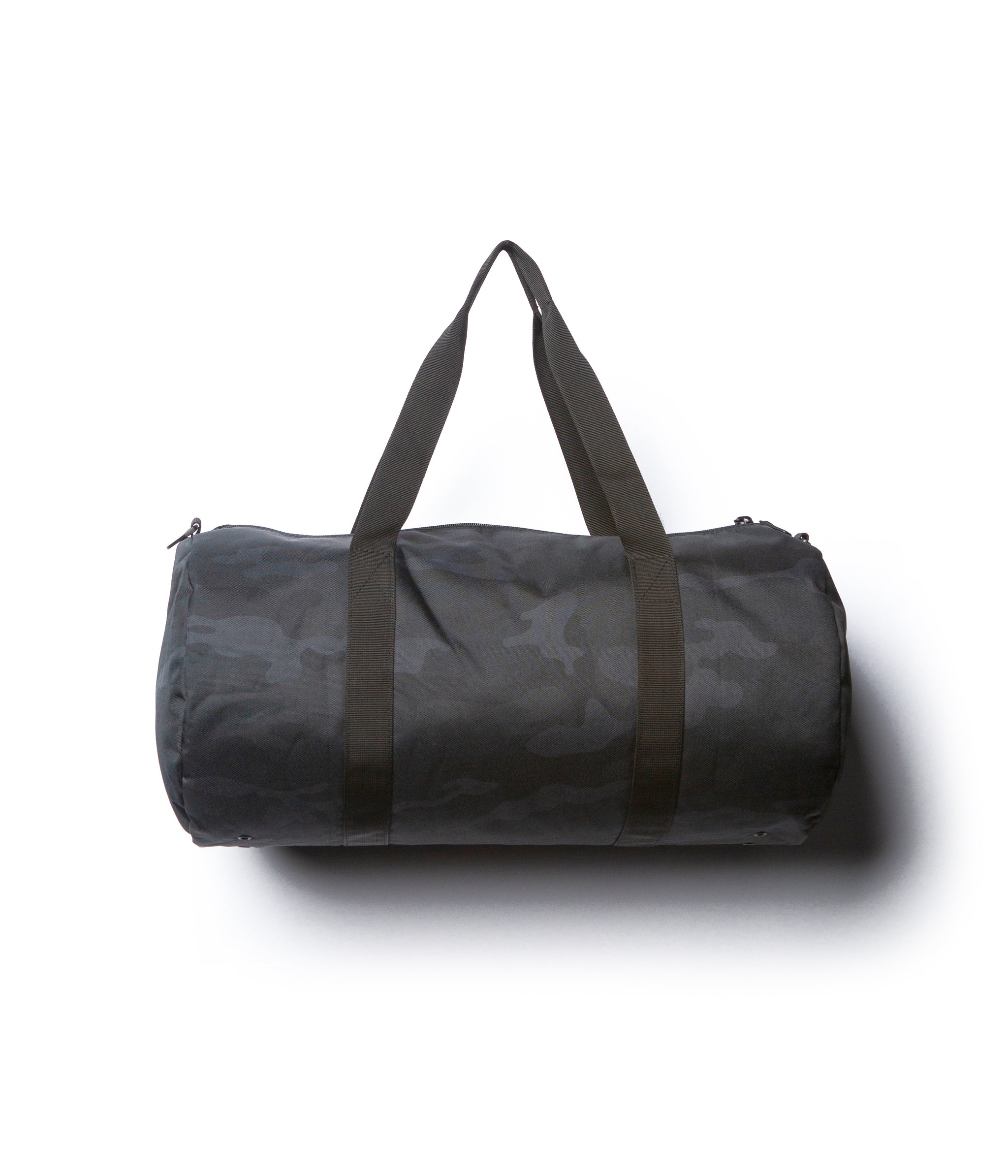 Day Tripper 29 Liter Duffle Bag made of durable polyester material with Nylon handles and removable shoulder strap in Black Camo